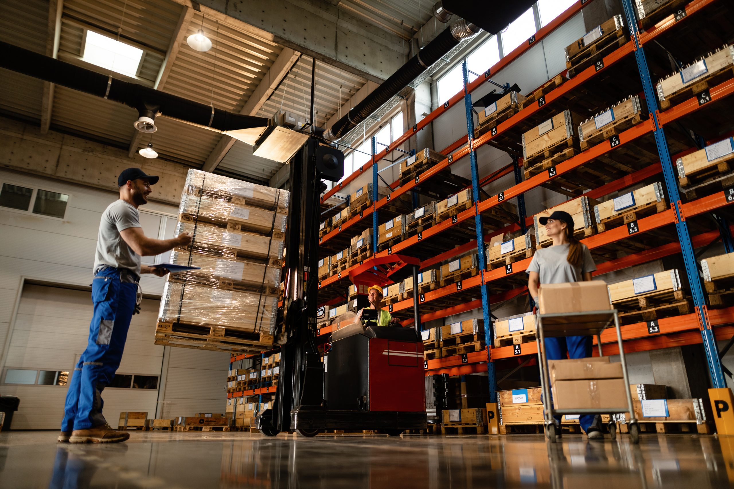 Below view of group of workers cooperating in a warehouse